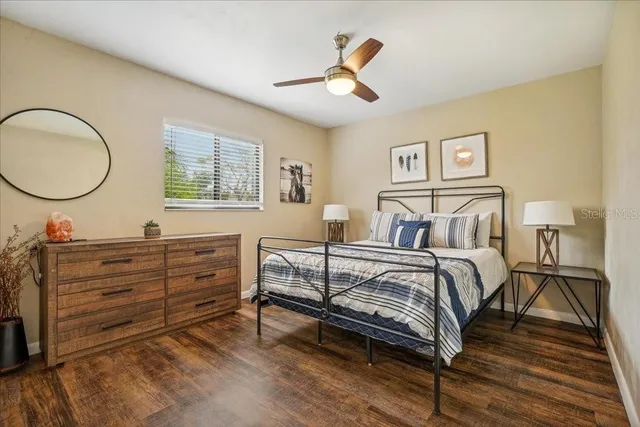 a bedroom with a bed and wooden floor