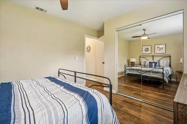 a bathroom with a granite countertop sink mirror vanity and toilet