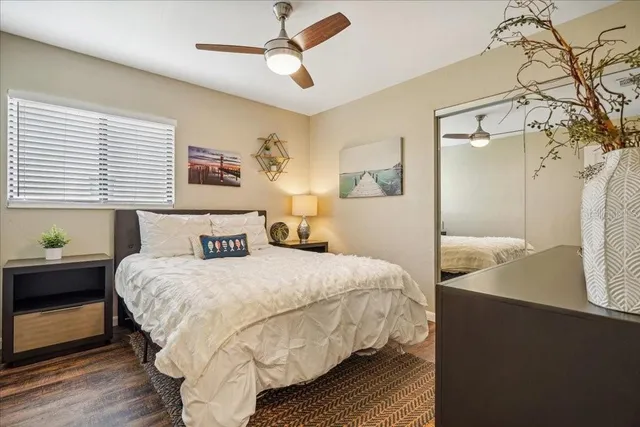 a bedroom with a bed and a large mirror