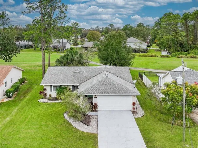 an aerial view of a house with garden space and street view