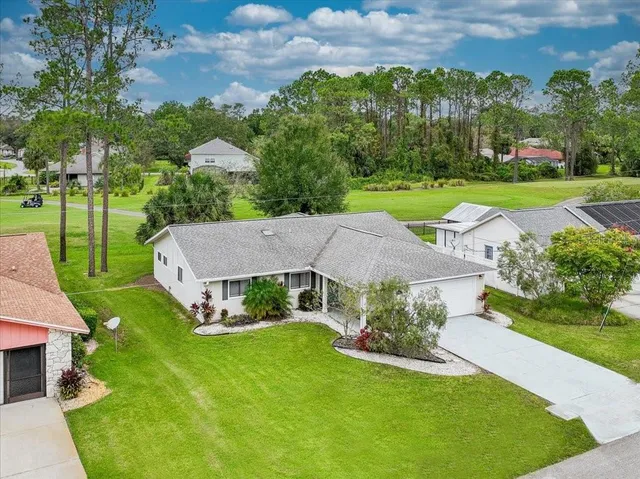a aerial view of a house with garden space and street view