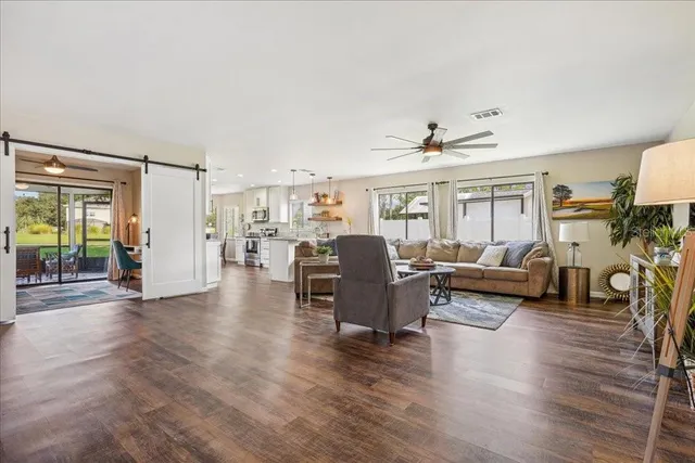 a living room with furniture and a wooden floor
