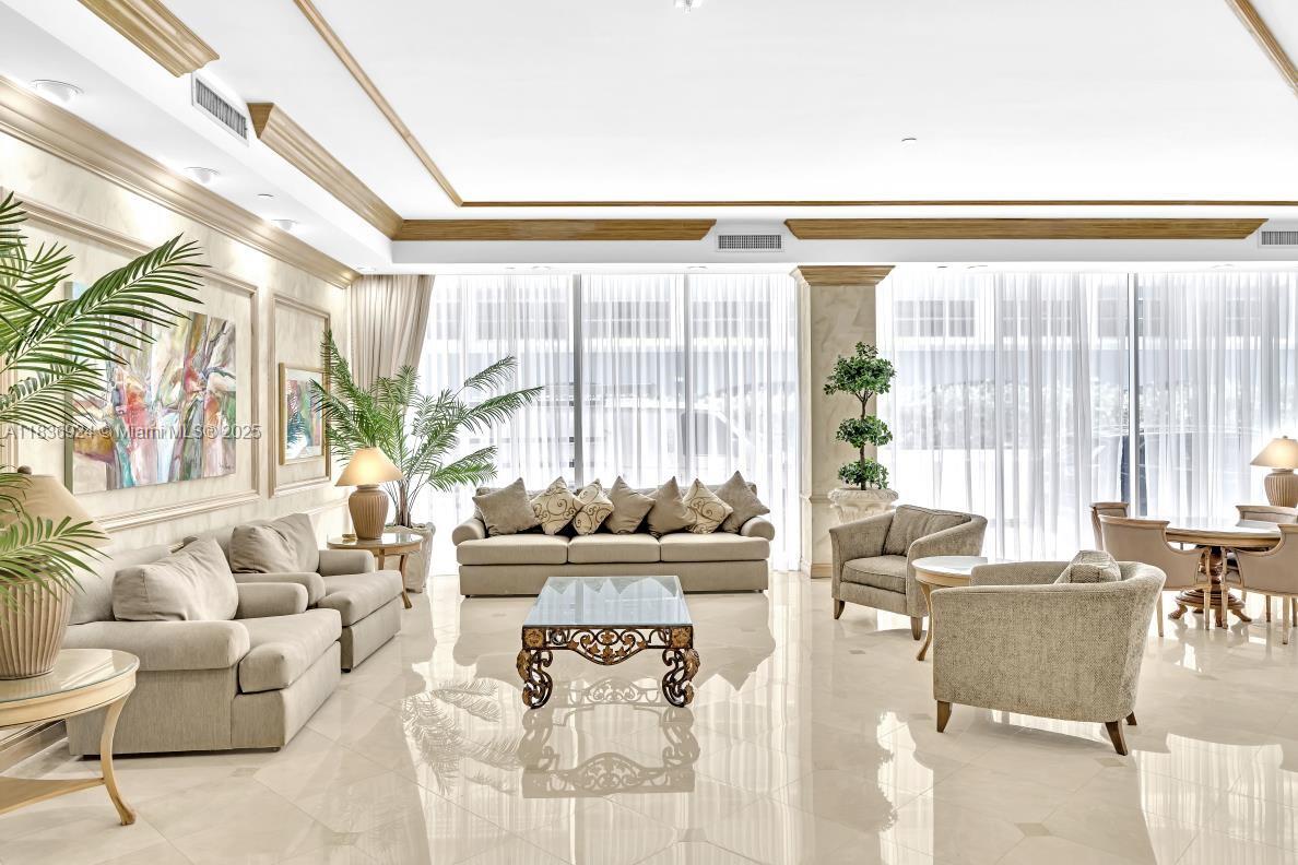 8855 Collins Avenue, Unit 2F Surfside, FL 33154 - Photo 17 of 79 a living room with furniture and a large window