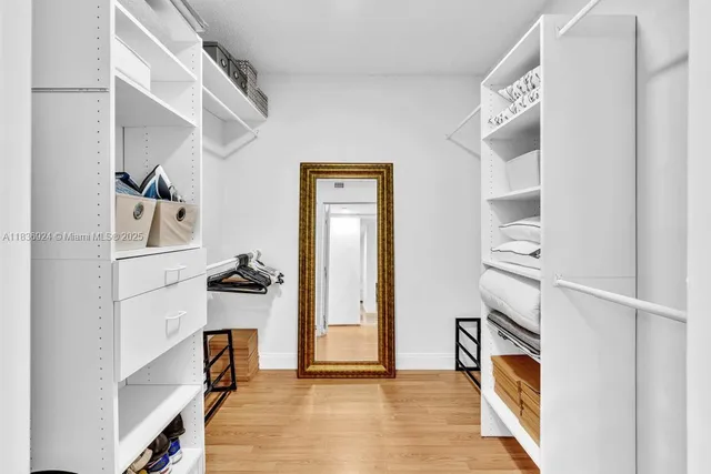 a bedroom with furniture and a flat screen tv