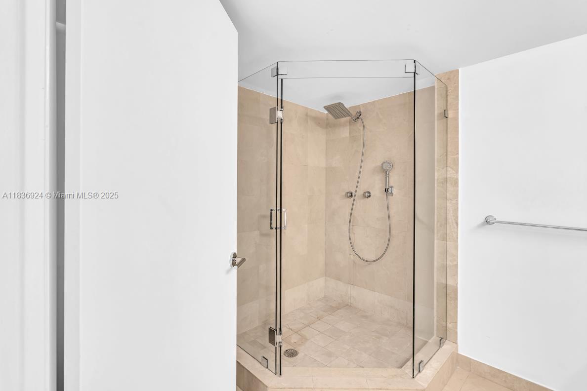 8855 Collins Avenue, Unit 2F Surfside, FL 33154 - Photo 19 of 79 a bathroom with a glass shower door