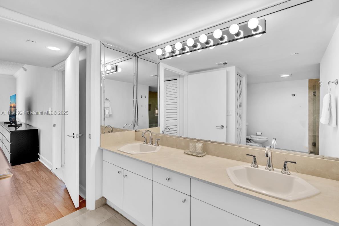 8855 Collins Avenue, Unit 2F Surfside, FL 33154 - Photo 22 of 79 a spacious bathroom with a double vanity sink mirror and double