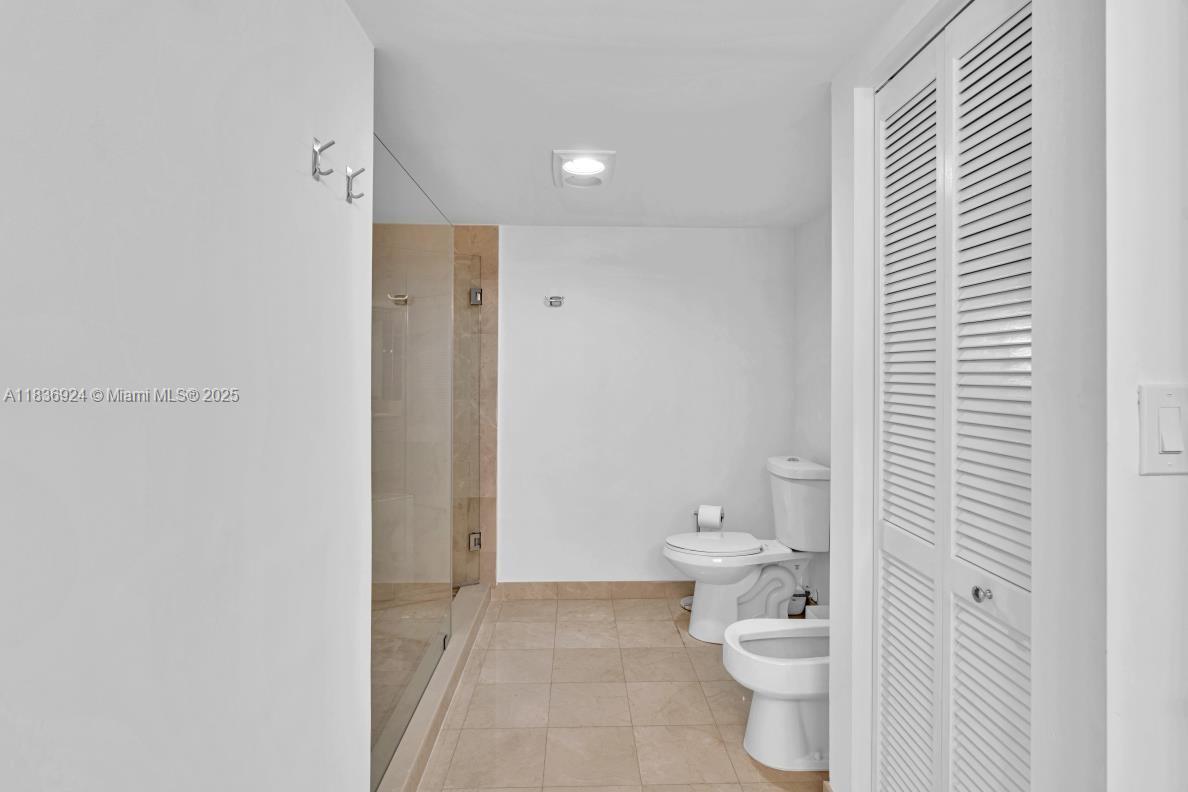 8855 Collins Avenue, Unit 2F Surfside, FL 33154 - Photo 28 of 79 a bathroom with a toilet and a shower
