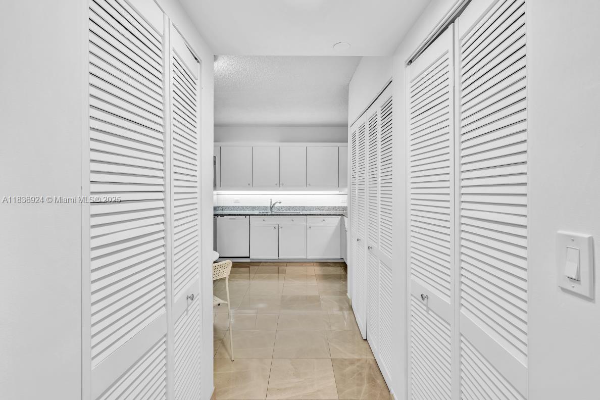 8855 Collins Avenue, Unit 2F Surfside, FL 33154 - Photo 33 of 79 a bathroom with a bathtub and a white door
