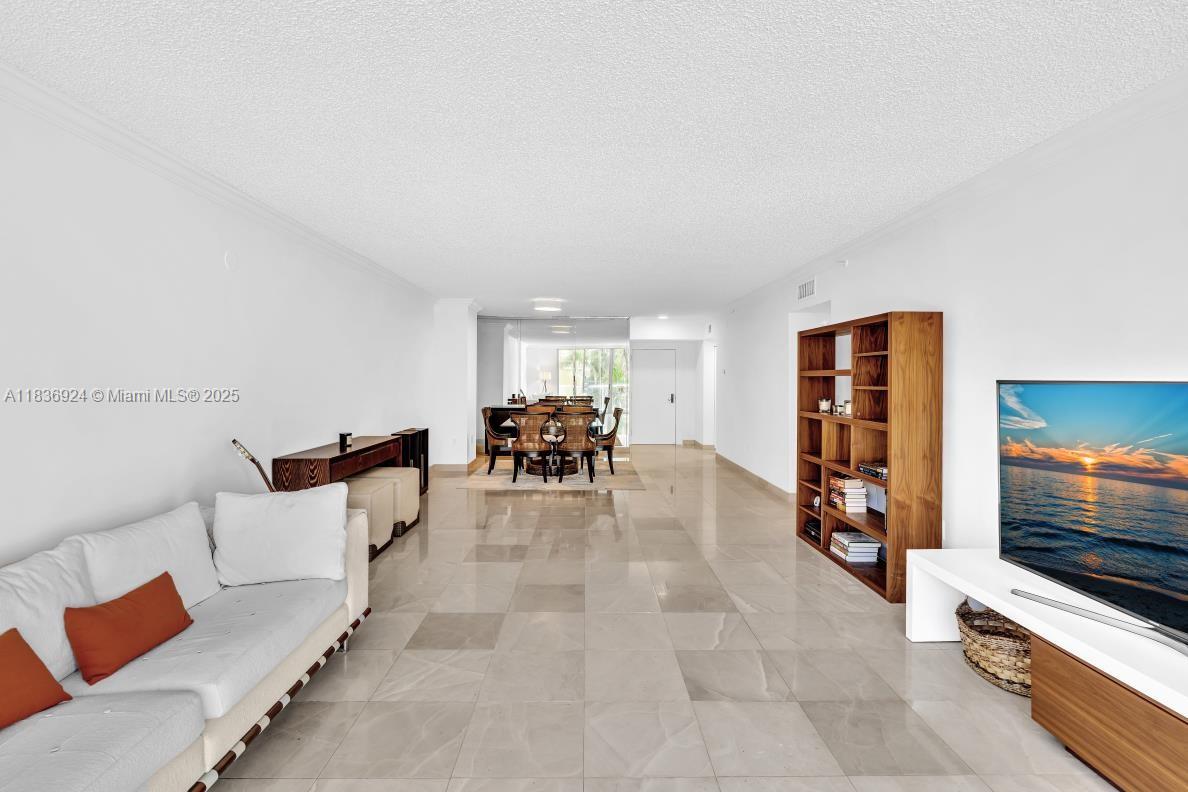 8855 Collins Avenue, Unit 2F Surfside, FL 33154 - Photo 38 of 79 a living room with furniture and a flat screen tv