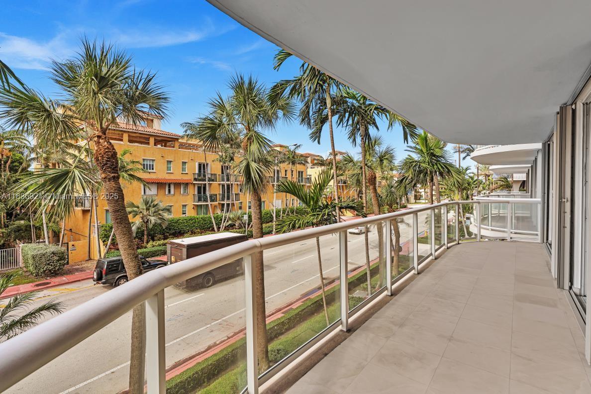 8855 Collins Avenue, Unit 2F Surfside, FL 33154 - Photo 40 of 79 a view of balcony with a palm tree