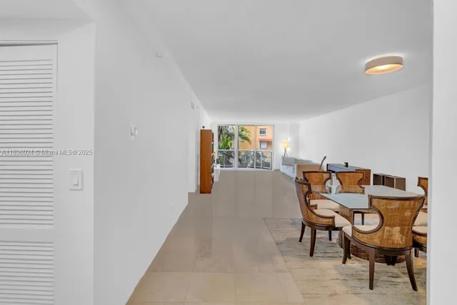 a view of a kitchen with kitchen island stainless steel appliances a table and chairs
