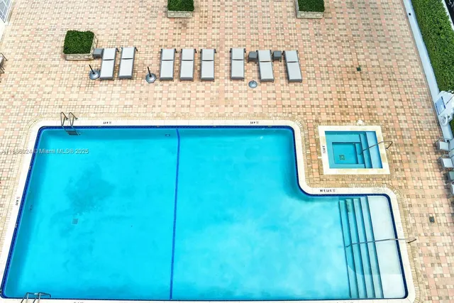 a room with pool table and windows