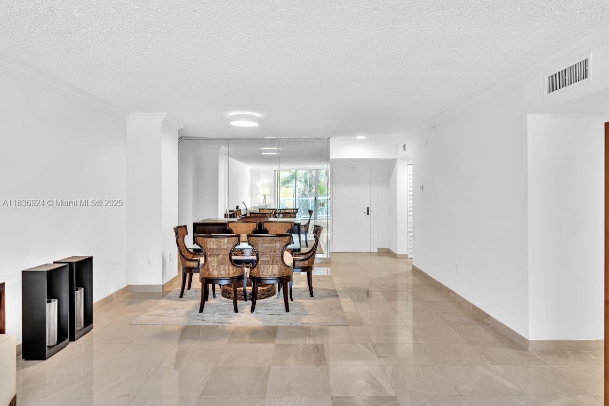 8855 Collins Avenue, Unit 2F Surfside, FL 33154 - Photo 57 of 79 a view of a dining room with furniture