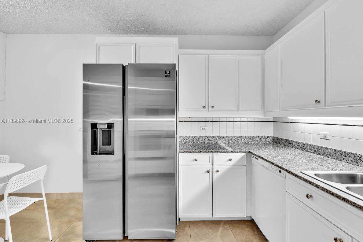 8855 Collins Avenue, Unit 2F Surfside, FL 33154 - Photo 60 of 79 a kitchen with a refrigerator sink and cabinets