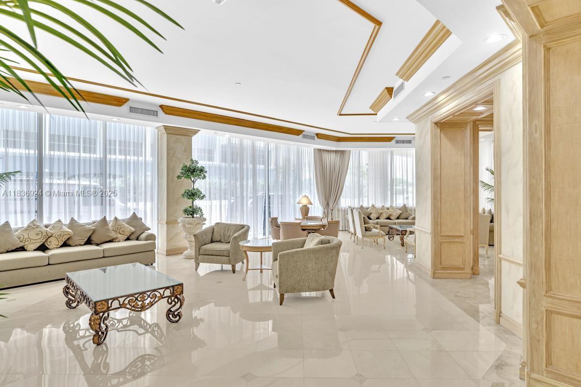 8855 Collins Avenue, Unit 2F Surfside, FL 33154 - Photo 65 of 79 a living room with furniture and floor to ceiling windows