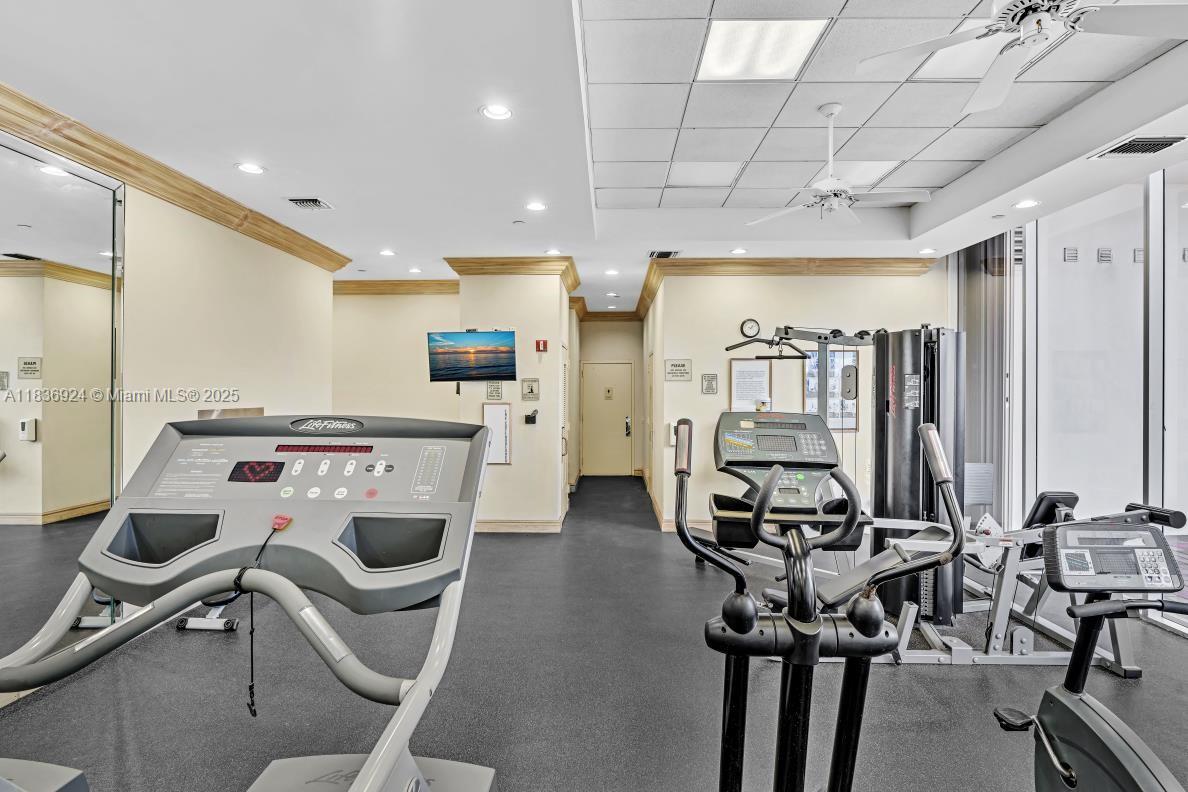8855 Collins Avenue, Unit 2F Surfside, FL 33154 - Photo 72 of 79 a view of a kitchen with kitchen island stainless steel appliances a table and chairs