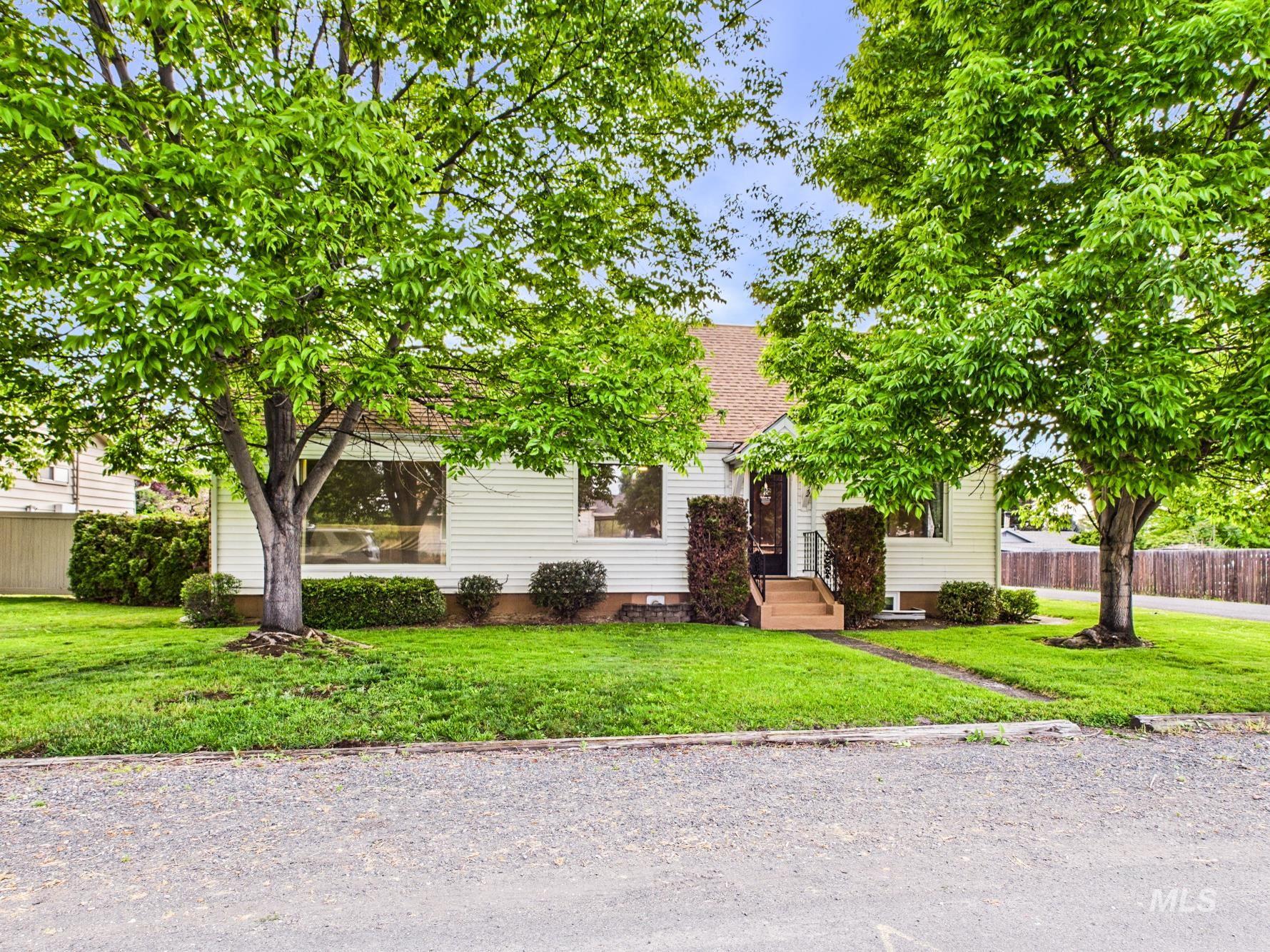 3422 6th Street Lewiston, ID 83501 - Photo 42 of 43 Single-story residence featuring white siding, a prominent front lawn, and mature trees