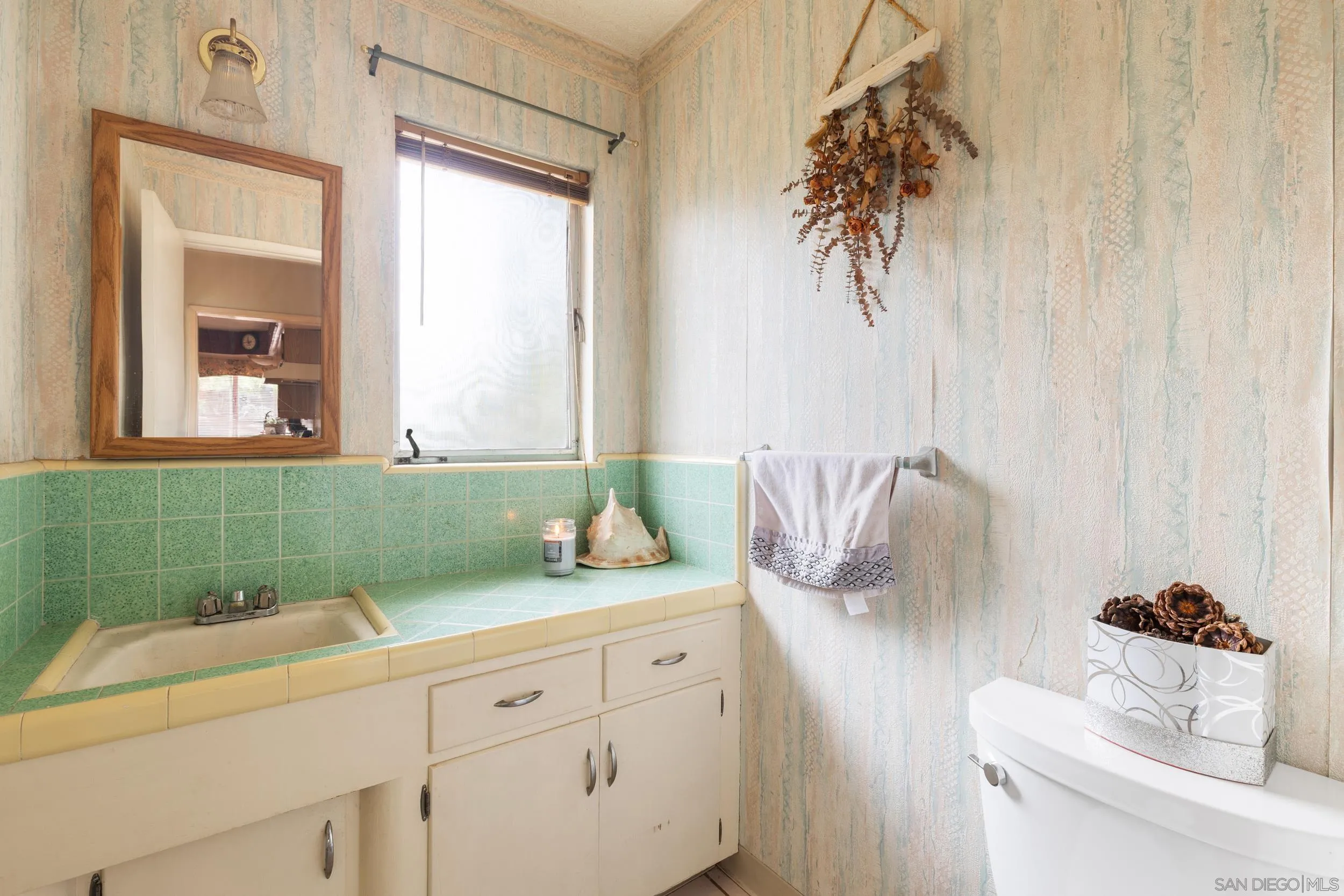 9361 Hollyhock Lane Spring Valley, CA 91977 - Photo 12 of 31 a bathroom with a granite countertop sink and a mirror