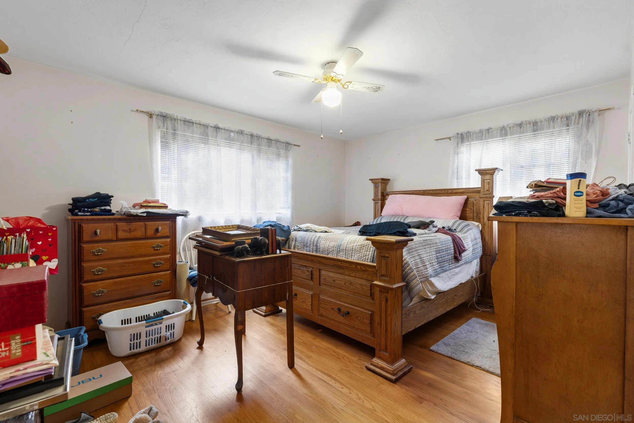 9361 Hollyhock Lane Spring Valley, CA 91977 - Photo 13 of 31 a bed room with a bed and a chandelier