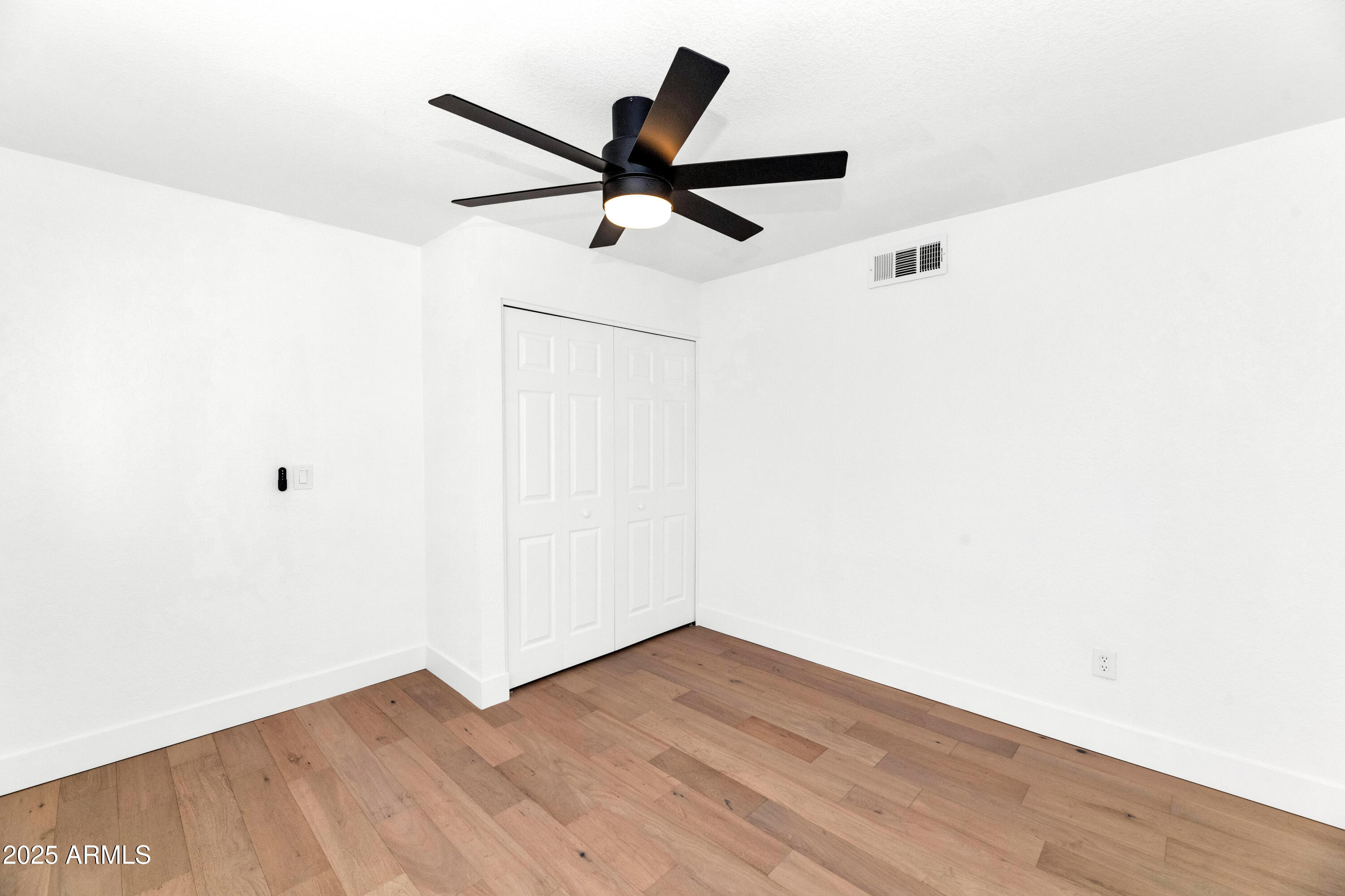 4642 North 31st Street Phoenix, AZ 85016 - Photo 29 of 50 a view of a ceiling fan with wooden floor