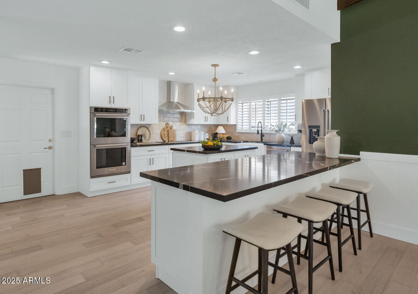 4642 North 31st Street Phoenix, AZ 85016 - Photo 3 of 50 a large kitchen with granite countertop a counter space chairs stainless steel appliances and cabinets