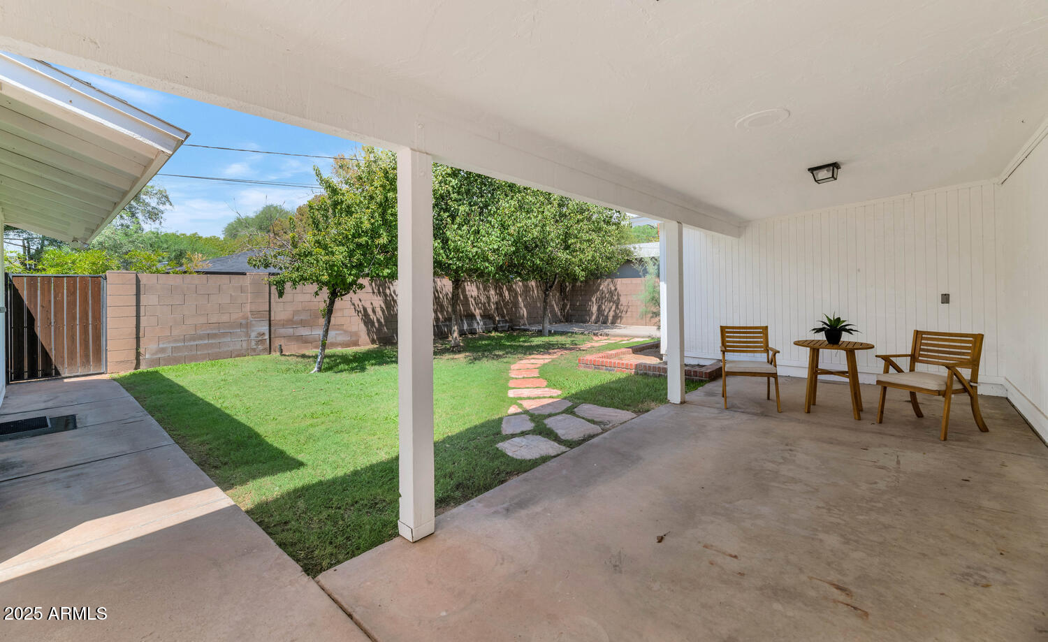 4642 North 31st Street Phoenix, AZ 85016 - Photo 37 of 50 a view of a patio with table and chairs next to a yard