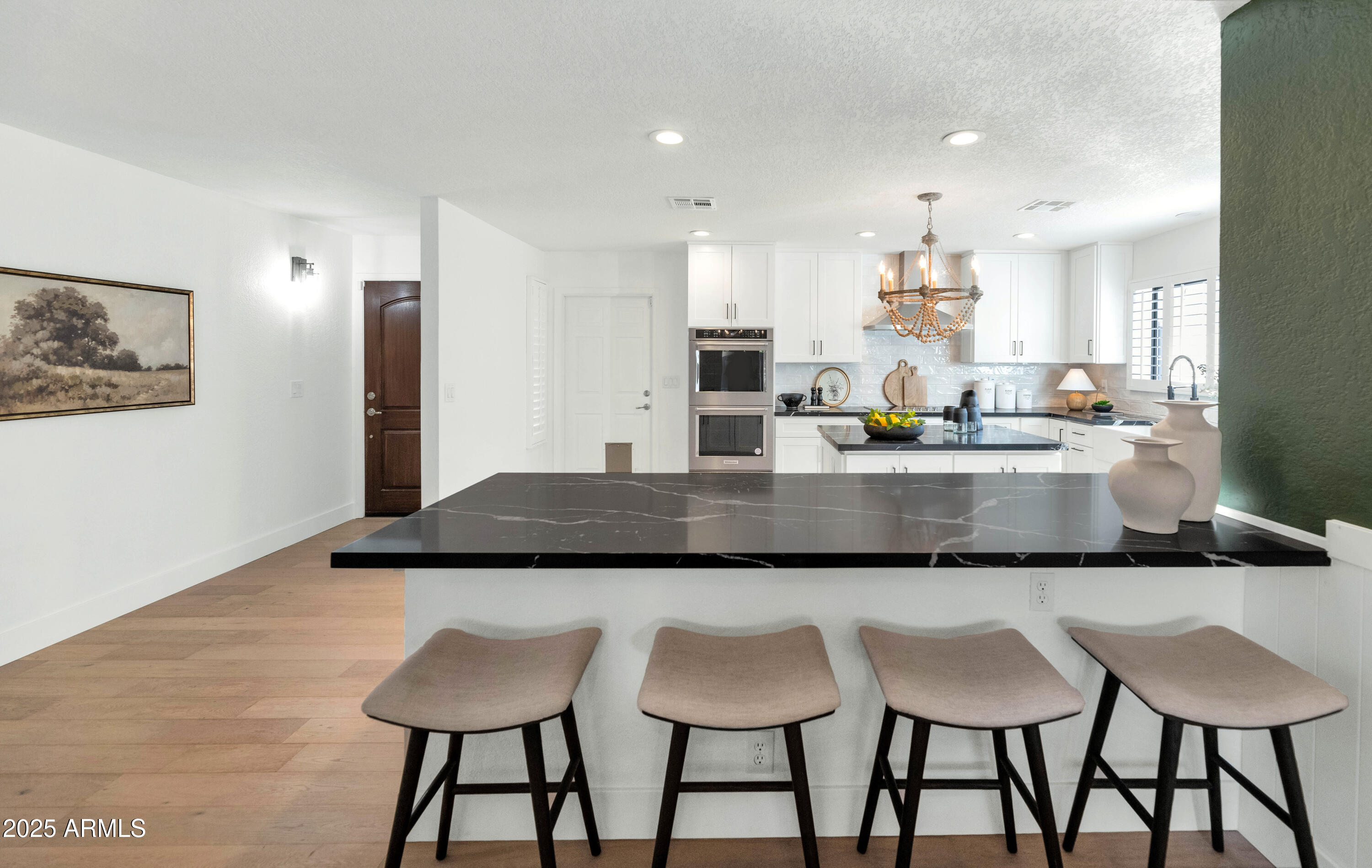 4642 North 31st Street Phoenix, AZ 85016 - Photo 10 of 50 a kitchen with granite countertop kitchen island cabinets and chairs in it