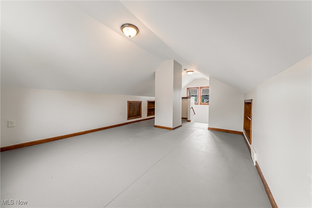 1271 Winston Road Cleveland, OH 44121 - Photo 34 of 43 Additional living space featuring concrete flooring and vaulted ceiling