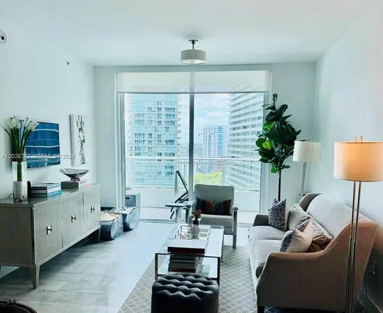 a room with furniture a lamp and a flat screen tv