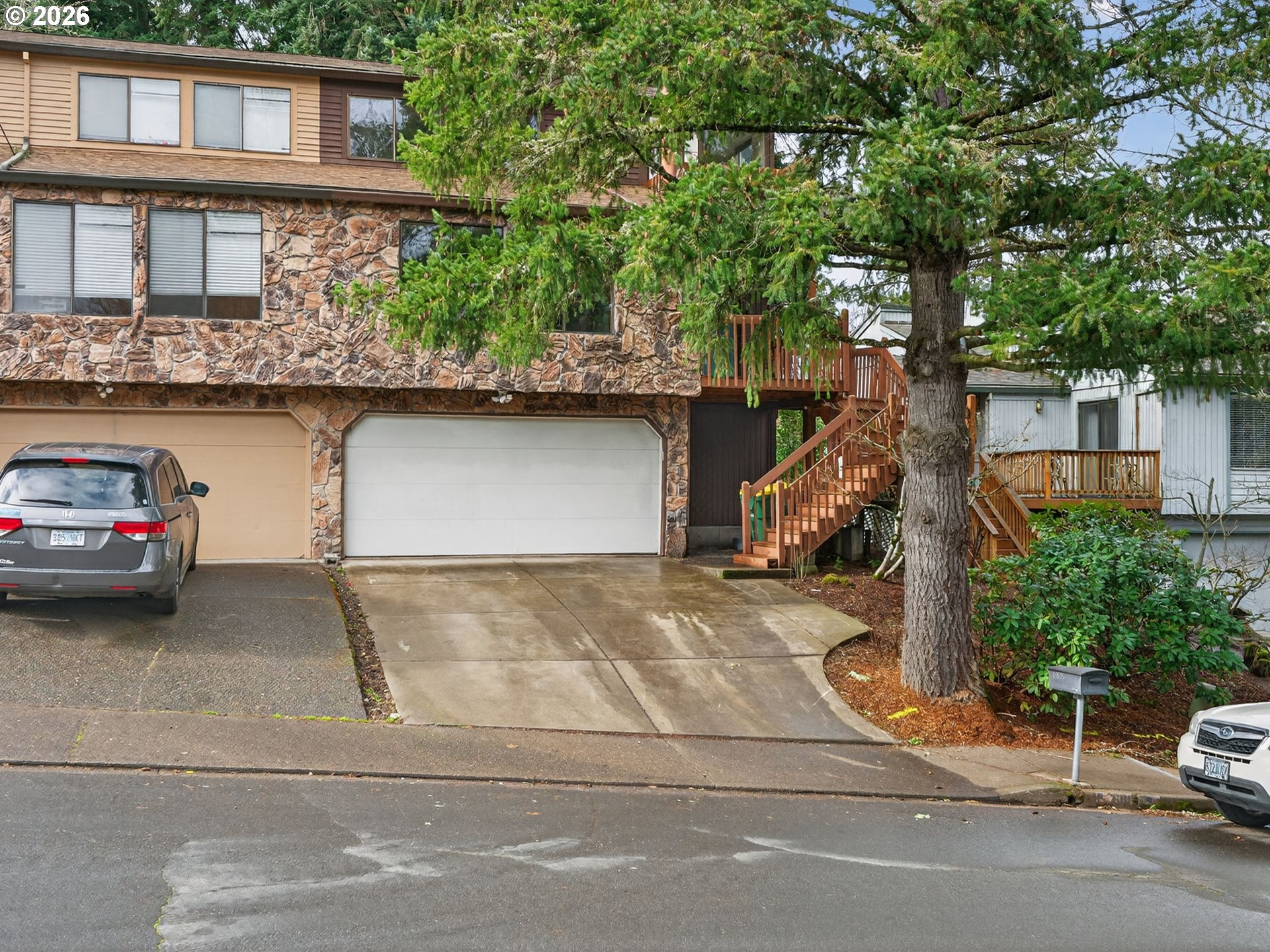 6805 Southwest 180th Avenue Beaverton, OR 97007 - Photo 2 of 29 a view of a car park in front of house