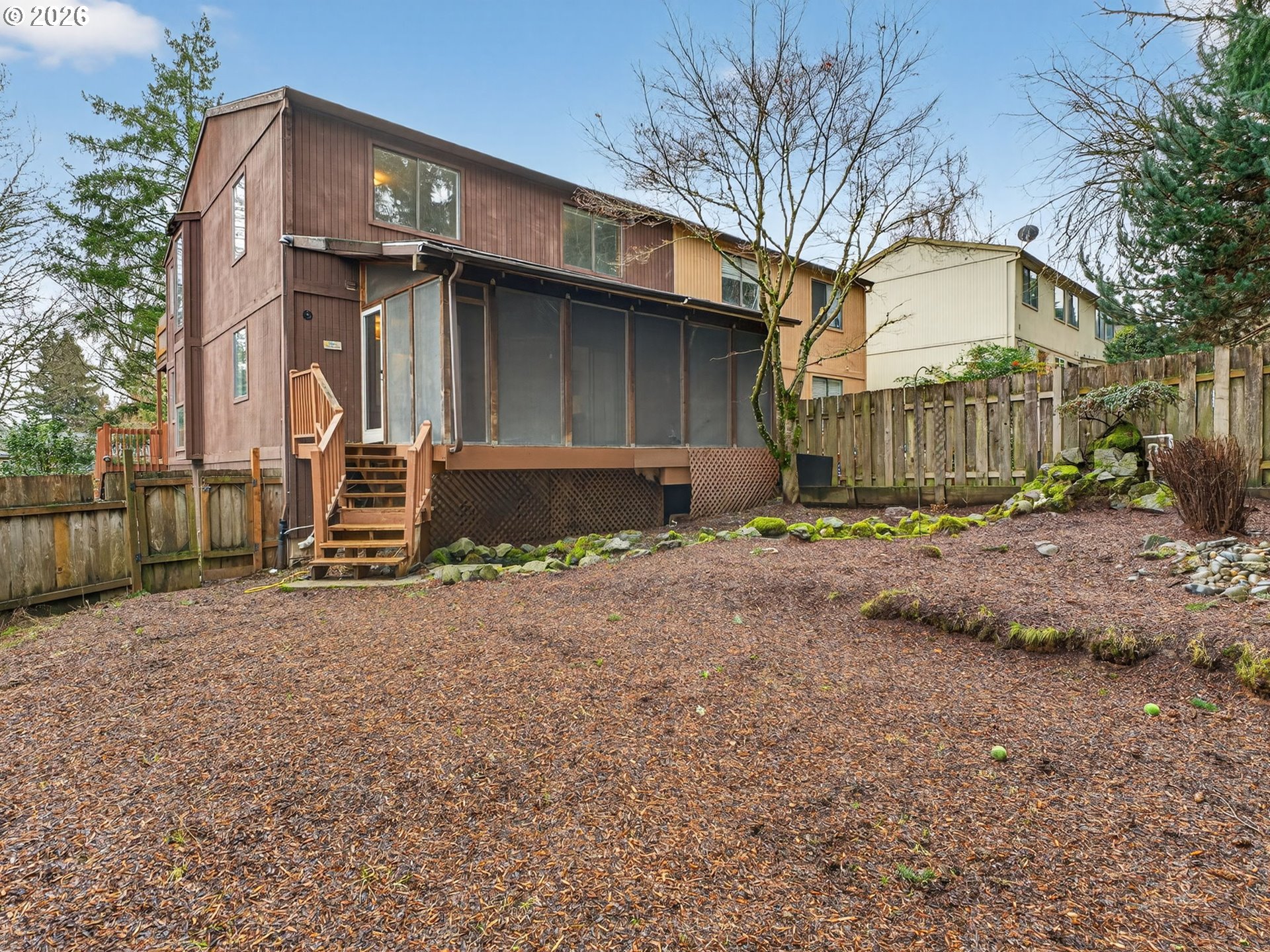 6805 Southwest 180th Avenue Beaverton, OR 97007 - Photo 27 of 29 a wooden house with a large tree in front of it