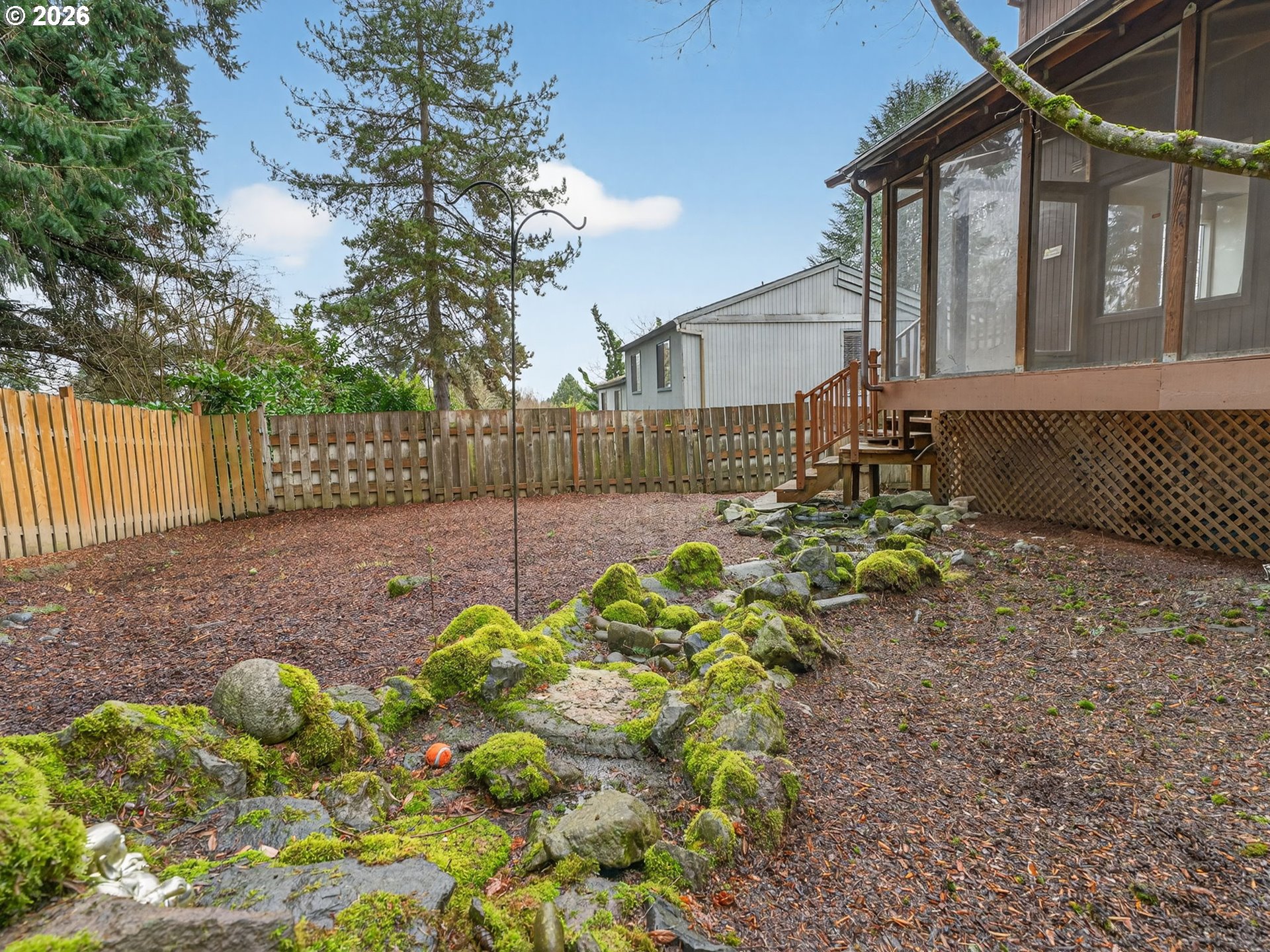 6805 Southwest 180th Avenue Beaverton, OR 97007 - Photo 28 of 29 a backyard of a house with lots of green space