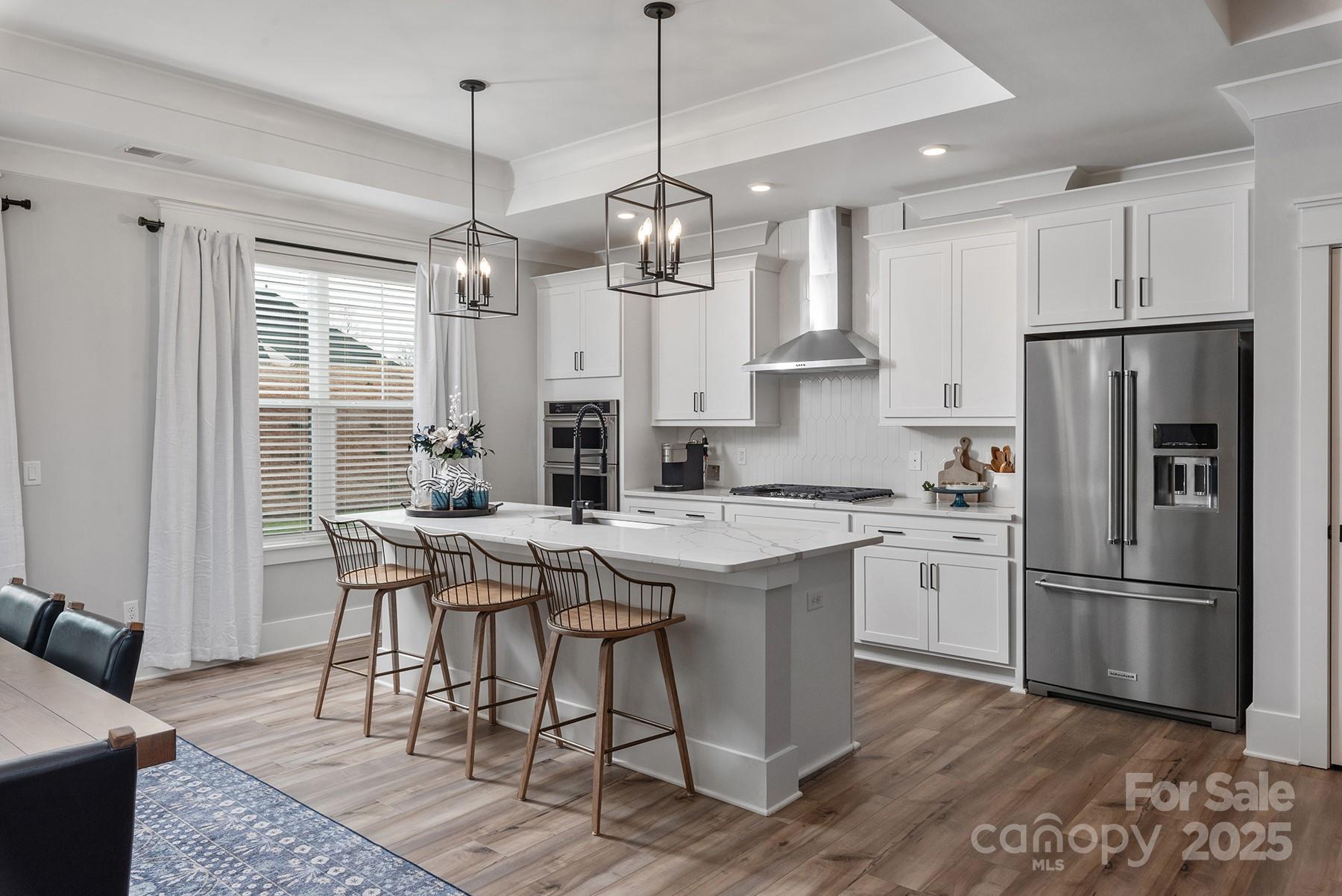 1945 Hendricks Street Rock Hill, SC 29732 - Photo 3 of 19 a kitchen with stainless steel appliances granite countertop a dining table chairs refrigerator and microwave