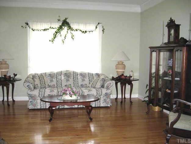 9116 Breeland Way Raleigh, NC 27613 - Photo 3 of 12 a living room with furniture and a chandelier