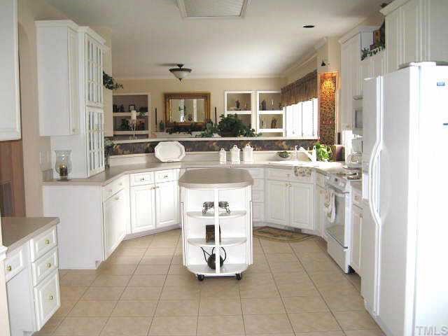 9116 Breeland Way Raleigh, NC 27613 - Photo 5 of 12 a kitchen with a sink refrigerator and cabinets
