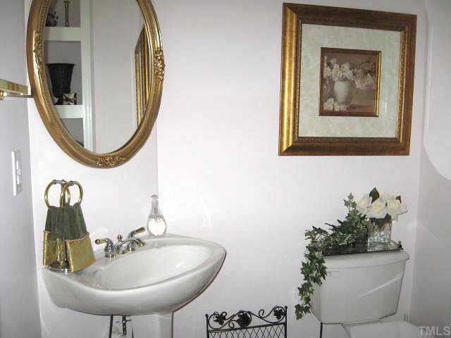 9116 Breeland Way Raleigh, NC 27613 - Photo 7 of 12 a bathroom with a sink and mirror