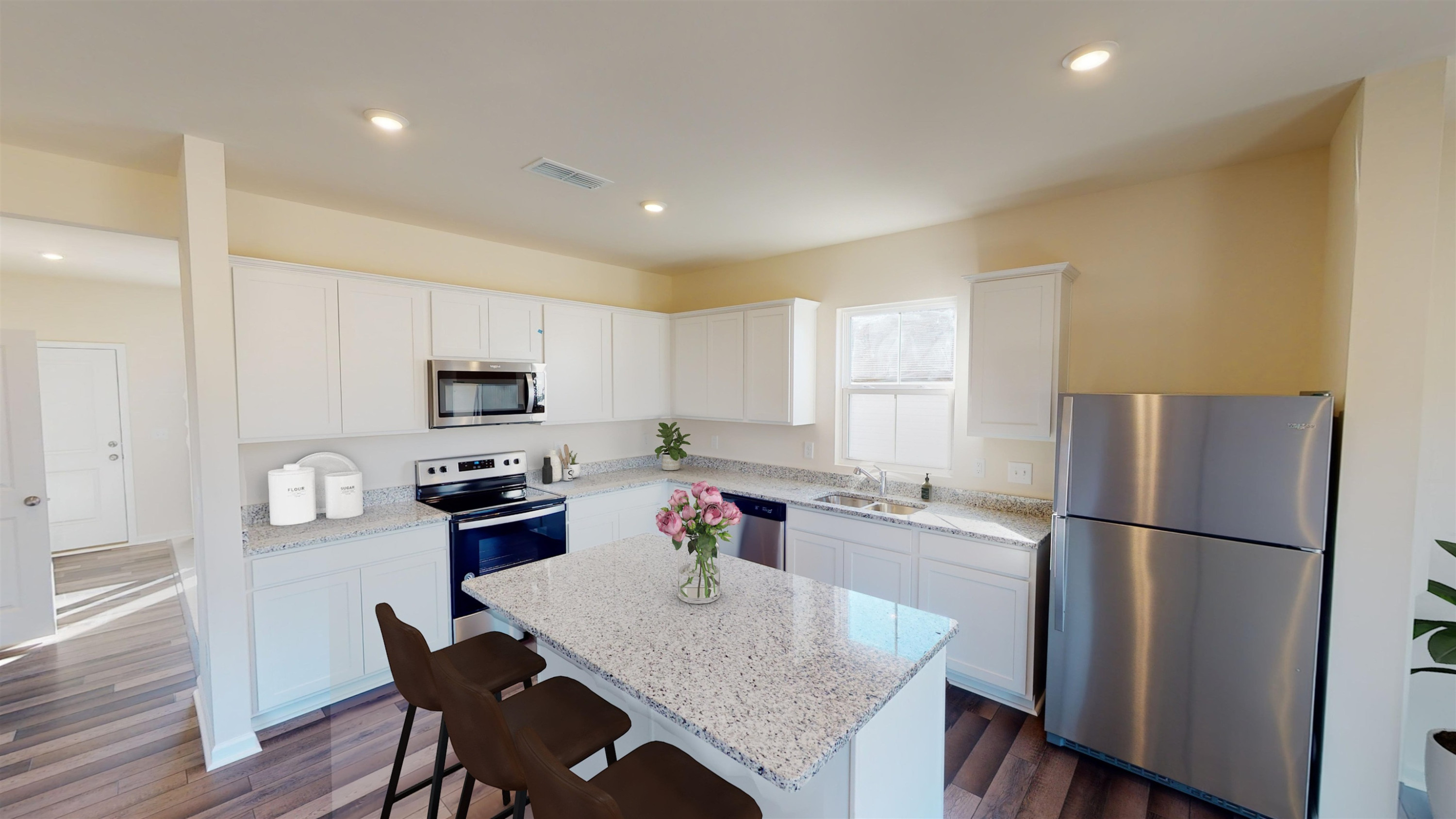 3424 Dragonfly River Raleigh, NC 27604 - Photo 10 of 28 a kitchen with stainless steel appliances granite countertop a refrigerator a stove a sink a dining table and chairs
