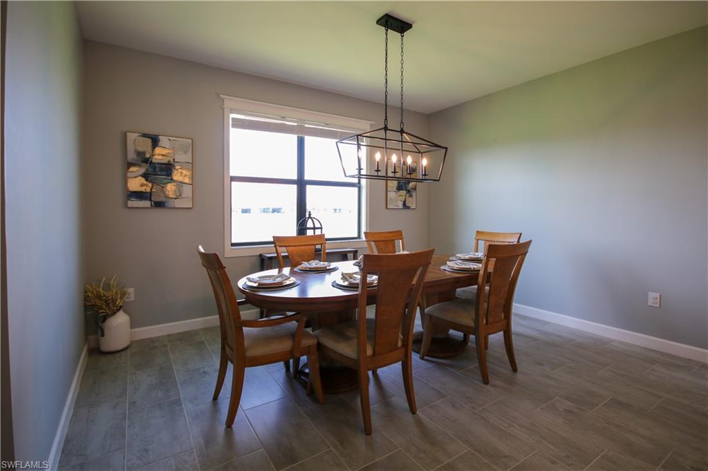 11461 Canopy Loop Fort Myers, FL 33913 - Photo 8 of 33 a view of a dining room with furniture window and wooden floor