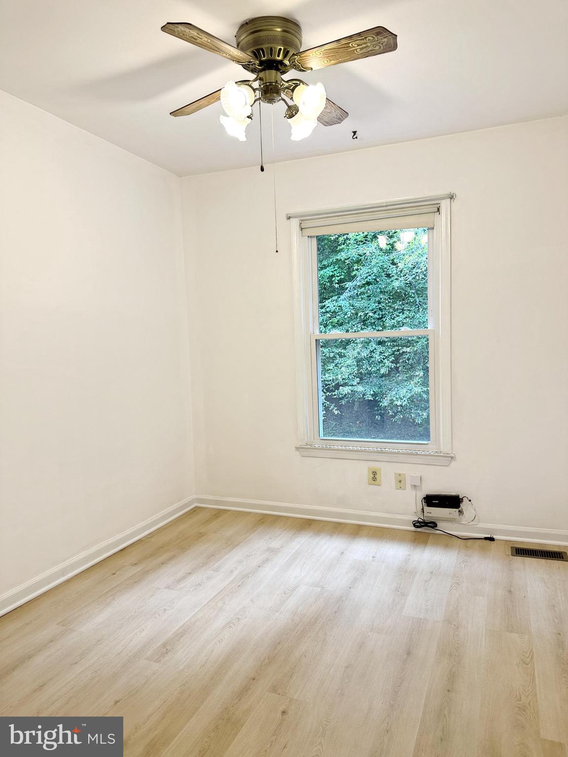 6260 Rathlin Drive Springfield, VA 22152 - Photo 11 of 27 an empty room with a window and a ceiling fan