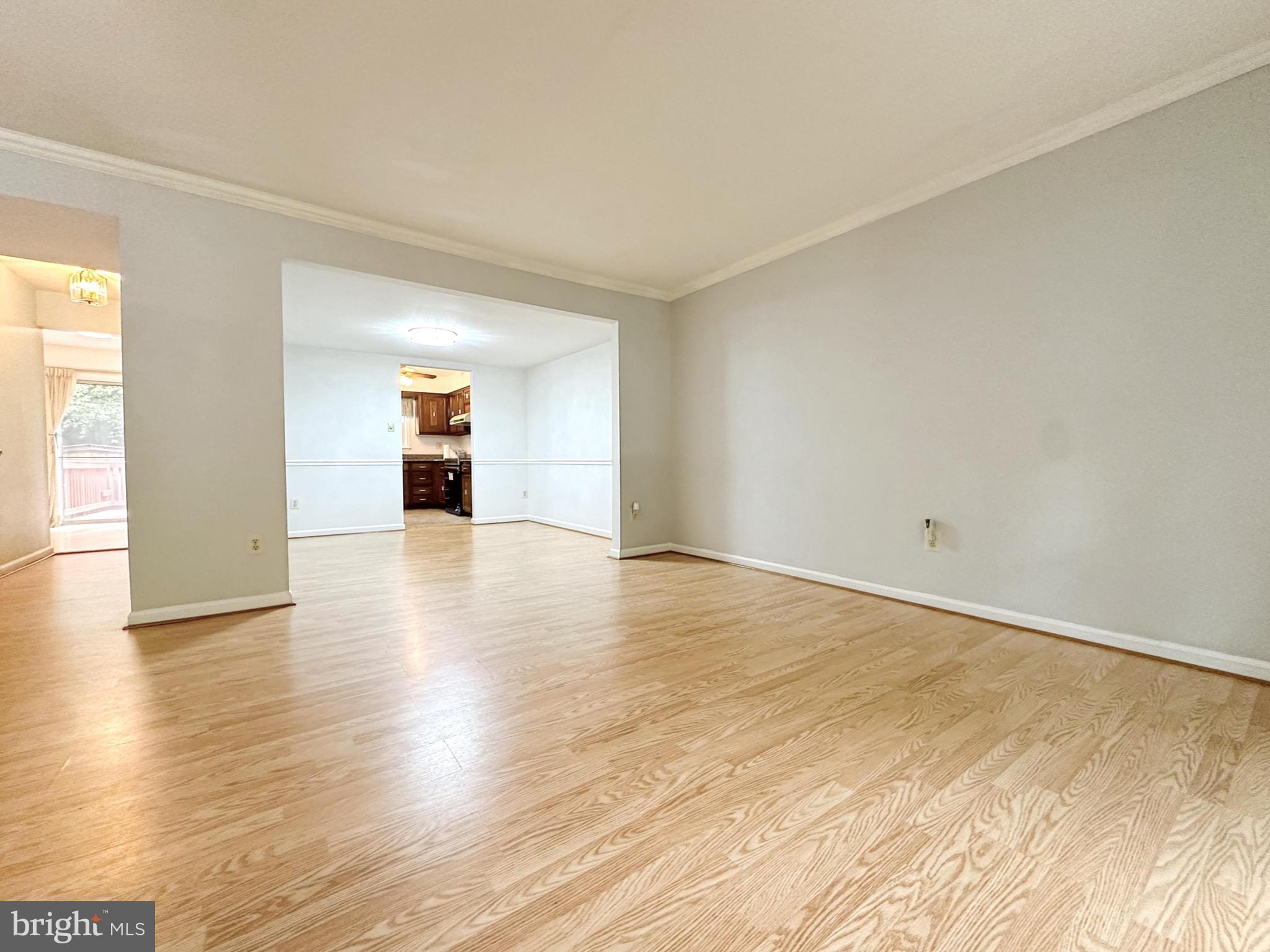 6260 Rathlin Drive Springfield, VA 22152 - Photo 2 of 27 an empty room with wooden floor and natural light