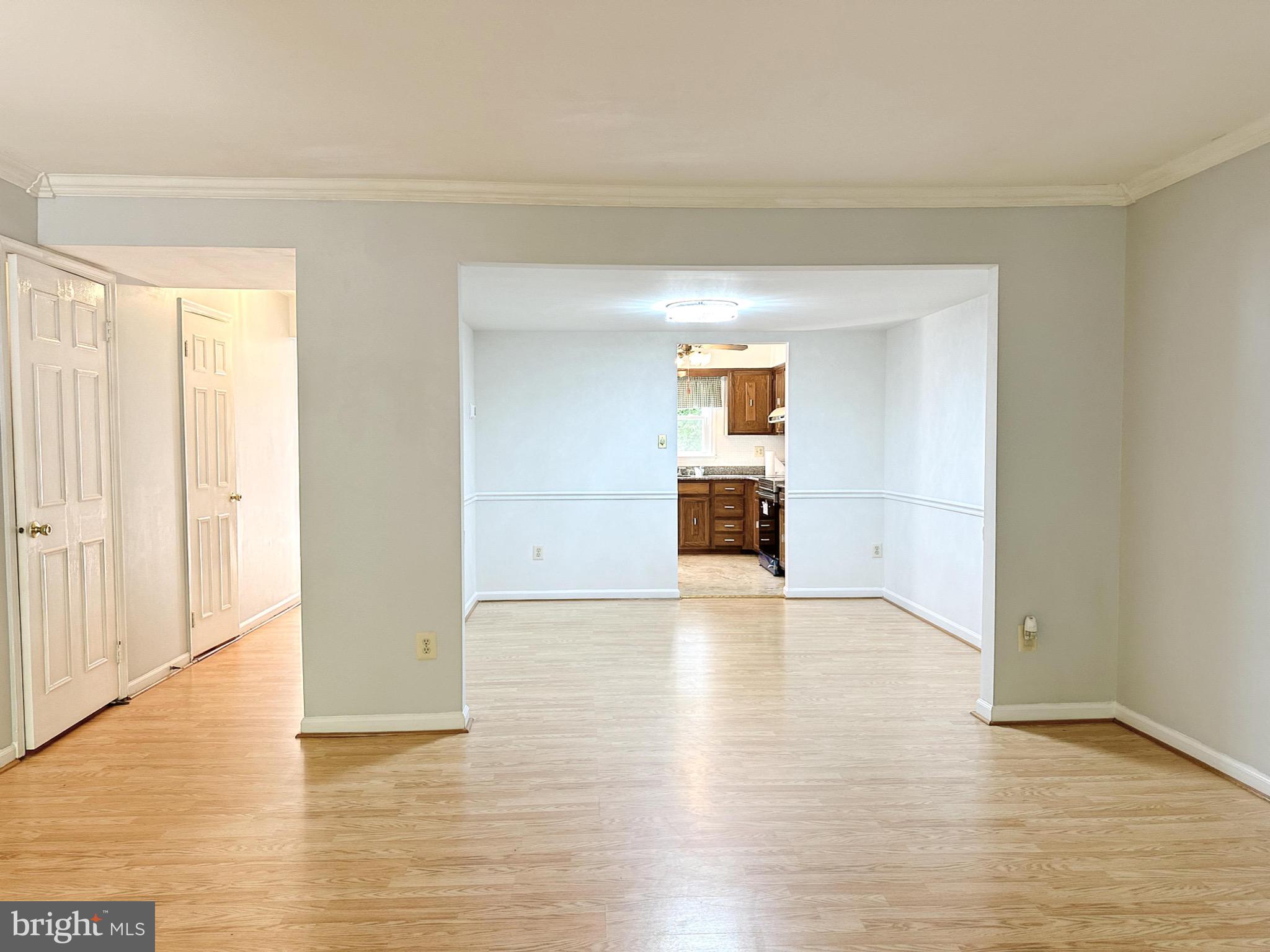 6260 Rathlin Drive Springfield, VA 22152 - Photo 3 of 27 a view of empty room with wooden floor and cabinet