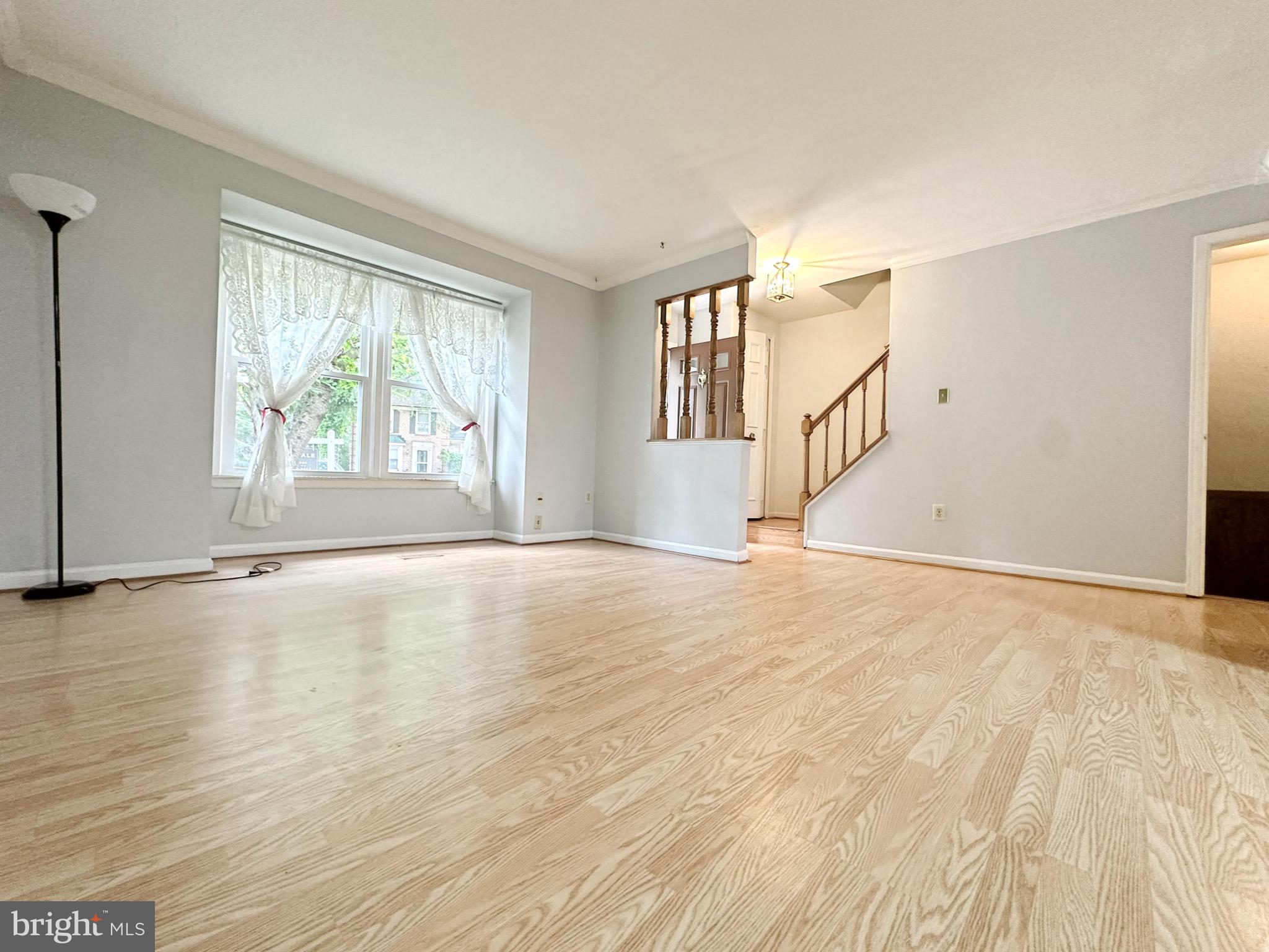 6260 Rathlin Drive Springfield, VA 22152 - Photo 4 of 27 a view of an empty room with wooden floor and a window