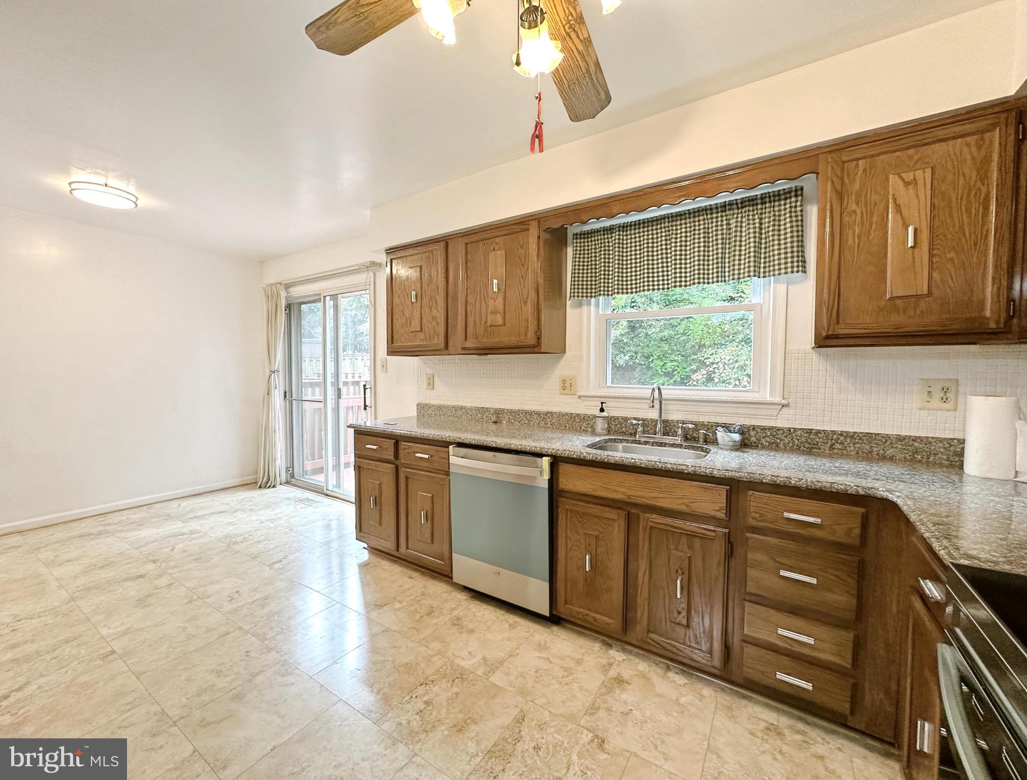 6260 Rathlin Drive Springfield, VA 22152 - Photo 7 of 27 a kitchen with stainless steel appliances granite countertop a sink window and cabinets
