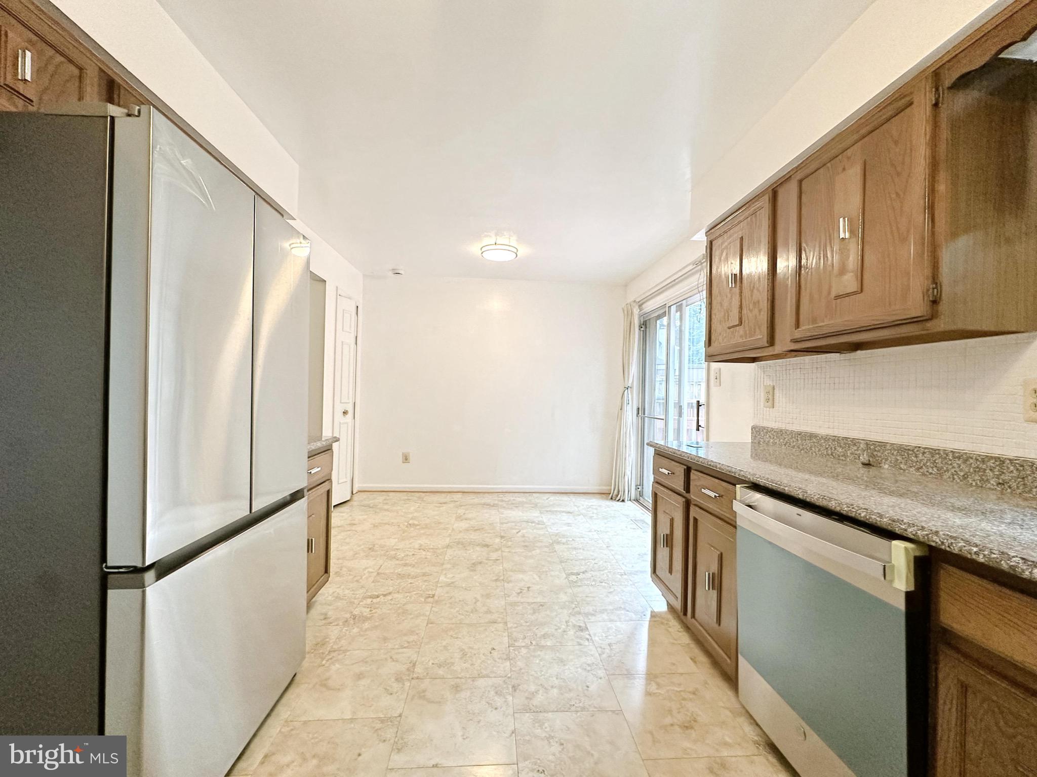 6260 Rathlin Drive Springfield, VA 22152 - Photo 8 of 27 a kitchen with granite countertop a refrigerator and a sink