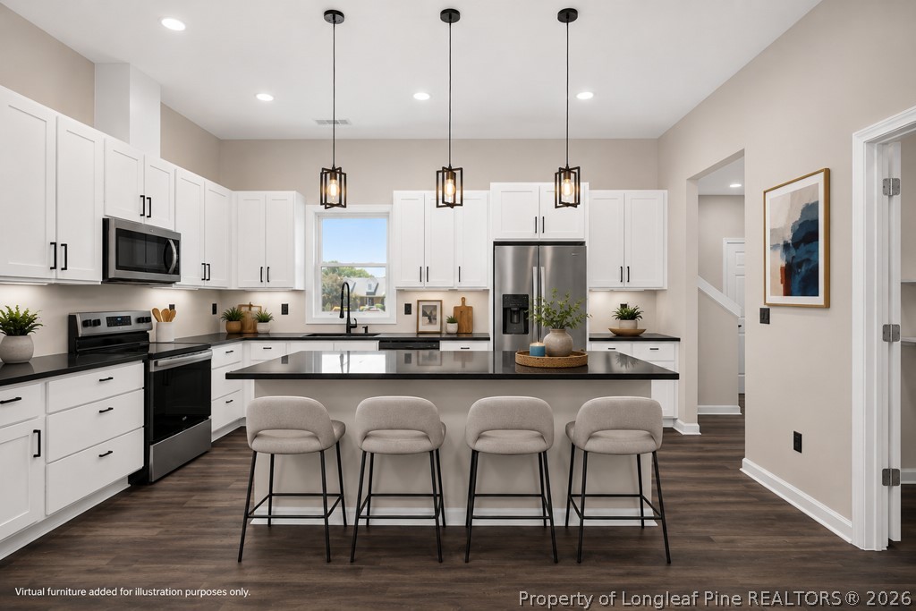 3025 Old Stage Road South Erwin, NC 28339 - Photo 12 of 50 a kitchen with stainless steel appliances granite countertop a stove a sink and a refrigerator