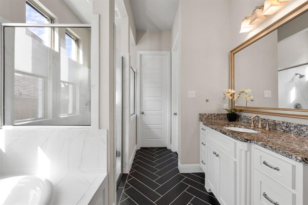 1806 Evening Star Road Frisco, TX 75033 - Photo 28 of 38 Bathroom featuring vanity, shower with separate bathtub, and tile patterned floors