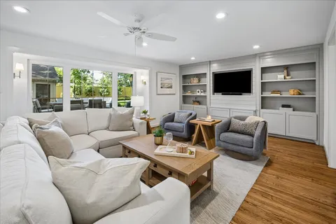 a living room with furniture flat screen tv and a fireplace