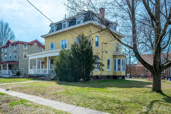 a front view of house with yard and green space