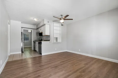 a view of a kitchen with a sink and a refrigerator