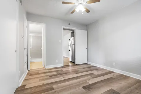 a view of a livingroom with wooden floor and chandelier